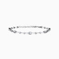 The 14K White Gold Diamond Station Bracelet features small round and teardrop-shaped diamonds spaced along a thin chain, showcased on a white background.