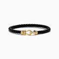 The Men's 14K Yellow Gold Diamond Accented Horseshoe Leather Bracelet features black braided leather and a gold, diamond-accented horseshoe clasp, shown against a plain white background.
