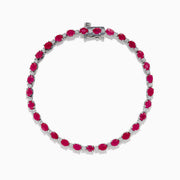The 925 Sterling Silver Ruby and Diamond Tennis Bracelet features a continuous row of round rubies and diamonds in prong settings, elegantly displayed in a circular shape against a white background.