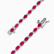 The 925 Sterling Silver Ruby and Diamond Tennis Bracelet features a continuous row of round rubies and diamonds in prong settings, elegantly displayed in a circular shape against a white background.