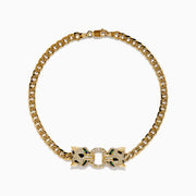 The Signature 14K Yellow Gold Diamond Panther Cuban Chain Bracelet features two opposing panther head clasps with small white and green gemstones, joined by a circular link, shown on a white background.