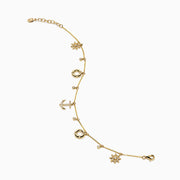 The 14K Yellow Gold Diamond Nautical Charm Bracelet features ship wheels, life rings, sparkling crystals, and a stone-adorned anchor. It includes an adjustable chain and lobster clasp for a perfect fit.
