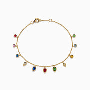 The 14K Yellow Gold Multi Sapphire Diamond Rain Drop Station Bracelet features small, vibrant sapphire charms in various shapes spaced evenly along a delicate gold chain, displayed against a white background.