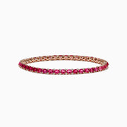 A slim 14k rose gold tennis bracelet featuring oval pink tourmalines and rubies totaling 6.56 TCW, set in a single row and displayed on a white background.