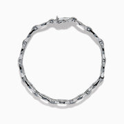 The 14K White Gold Diamond Oval Chain-Link Bracelet showcases a modern and elegant design, featuring alternating smooth and diamond-encrusted oval links, displayed on a white background.