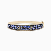 A 14K yellow gold bangle bracelet featuring tanzanite and diamond accents in a starfish design.
