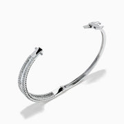 The Classique 14K White Gold Diamond Bangle features two rows of round diamonds and a central row of baguette-cut diamonds, elegantly set against a plain white background.