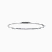 The Classique 14K White Gold Flexible Diamond Bangle features a sleek, minimalist design with a polished finish and a thin row of sparkling diamonds along the top half for effortless elegance.