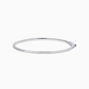 The Classique 14K White Gold Flexible Diamond Bangle features a sleek, minimalist design with a polished finish and a thin row of sparkling diamonds along the top half for effortless elegance.