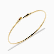 The D'Oro 14K Yellow Gold Pave Diamond Flexible Bangle features a slim, flexible design with a row of sparkling pave diamonds along the top half, shown against a plain white background.