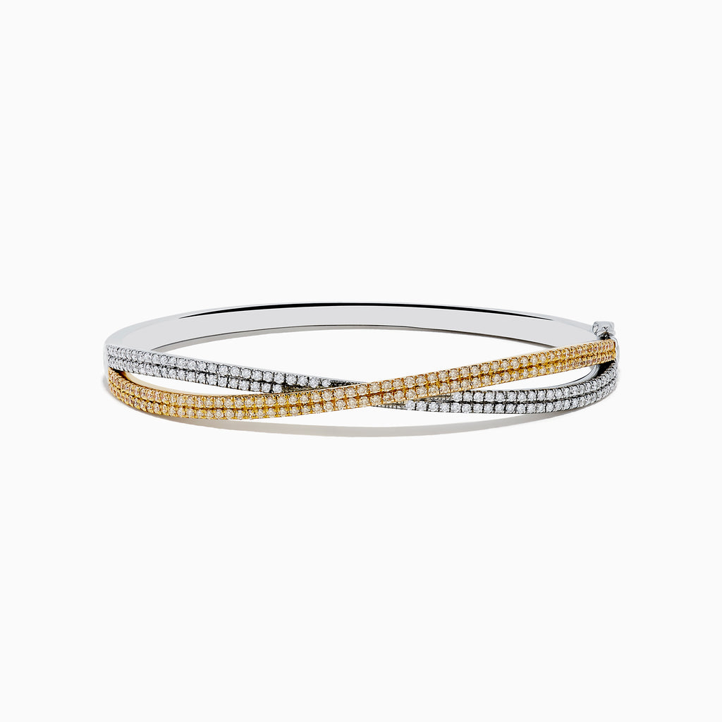 The Canare 14K Two Tone White and Yellow Diamond Criss Cross Bangle features intertwined bands of white and yellow gold, each adorned with sparkling diamonds for a dazzling effect.