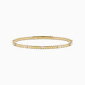 The 14K Yellow Gold Diamond Station Flexible Bangle features smooth rectangular links and evenly spaced round diamonds, offering minimalist elegance in a thin, flexible design perfect for any occasion.