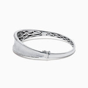 The 925 Sterling Silver Diamond Accented Bangle features a smooth, slightly curved center, two rows of sparkling stones along the edges, and a decorative lattice pattern inside.