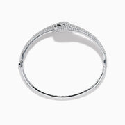 The Signature 14K White Gold White and Black Diamond Panther Bypass Bangle showcases two panther heads with sparkling diamond accents facing each other in an elegant, bypass-style design.