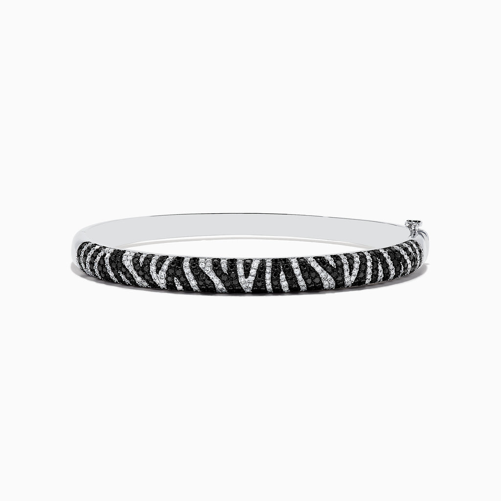 The 14k White Gold Black and White Diamond Zebra Print Bangle features a striking zebra stripe design with black and white diamond accents, elegantly set against plain white gold.