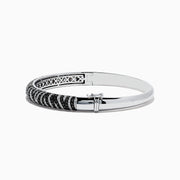 The 14k White Gold Black and White Diamond Zebra Print Bangle features a striking zebra stripe design with black and white diamond accents, elegantly set against plain white gold.