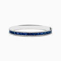 The Royale Bleu 14K White Gold Blue Sapphire and Diamond Bangle showcases a row of rectangular blue sapphires bordered by sparkling diamonds, elegantly set against a white background.