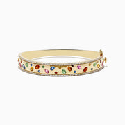 The Watercolor 14k Yellow Gold Bezel Set Multi Sapphire Bangle features vibrant sapphires set in 14k yellow gold, bordered with sparkling white diamonds for an elegant touch.