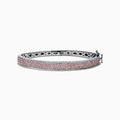 The 14K Two Tone Gold Pink and White Diamond Bangle features an intricate cutout design, accented by a central band with sparkling pink and white diamonds.