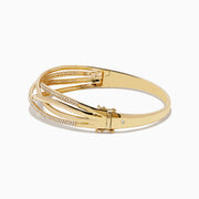 The Doro 14K Yellow Gold Diamond Crossover Bangle features interwoven gold bands, some set with sparkling white diamonds, for a sophisticated, shimmering look.