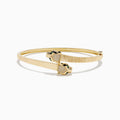 The Signature 14K YGold Diamond and Emerald Panther Bypass Bangle features twin panther heads with emerald eyes, diamond accents, and a textured ribbed band for a distinct, elegant look.