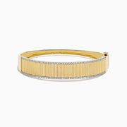 The DOro 14K Yellow Gold Diamond Bangle showcases a textured vertical striped design with sparkling diamonds bordering the top and bottom edges.