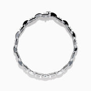 The Classique 14K White Gold Diamond Bracelet features interlocking H-shaped links and is adorned with sparkling diamonds, offering a polished, luxurious look.