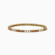 The Espresso 14K Yellow Gold Brown and White Diamond Tennis Bracelet features a single row of alternating brown and white diamonds, showcased against a plain white background.
