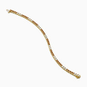 The Espresso 14K Yellow Gold Brown and White Diamond Tennis Bracelet features a single row of alternating brown and white diamonds, showcased against a plain white background.