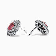 The Ruby Royale 18K White Gold Ruby and Diamond Earrings feature oval red rubies encircled by two halos of sparkling white diamonds, all set in elegant 18K white gold.