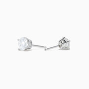 The 14K White Gold 1.18ct Brilliant Round Diamond Solitaire Stud Earrings feature sparkling diamonds in classic prong settings, showcased on a simple white background.