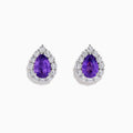 The 18K White Gold Purple Sapphire and Diamond Halo Earrings showcase teardrop-shaped purple sapphires encircled by sparkling diamonds, set against a white background.
