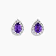 The 18K White Gold Purple Sapphire and Diamond Halo Earrings showcase teardrop-shaped purple sapphires encircled by sparkling diamonds, set against a white background.