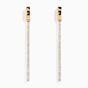 The 14K Yellow Gold Diamond Linear Bar Drop Huggie Earrings feature long, slender vertical bars accented with sparkling diamonds, displayed against a plain white background.