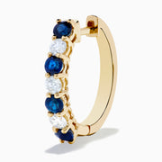 The 14K Yellow Gold Blue Sapphire & Diamond Hoop Earrings, 1.10 TCW, feature alternating sapphires and diamonds in a classic hoop design, shown on a plain white background with visible shadows.