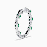 The 14K White Gold Emerald and Diamond Hoops showcase alternating round emeralds and diamonds in silver hoops, displayed against a white background.