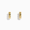 The 14K Yellow Gold Polished Heart Huggie Hoop Earrings feature a vertical row of shiny heart-shaped segments, elegantly displayed against a plain white background.