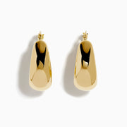 A pair of 14K yellow gold graduated oval chunky hoop earrings with a smooth, curved surface and clasp fastening, displayed on a white background.