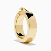 The 14K Yellow Gold Rectangular Bold Huggie Earrings feature smooth, polished surfaces and a shiny finish, shown against a plain white background.