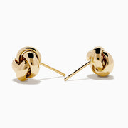 The 14K Yellow Gold Love Knot Stud Earrings are shown on a plain white background, highlighting their shiny finish.