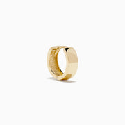 The 14K Yellow Gold Huggies are simple, small earrings with a smooth, shiny finish, shown on a plain white background.