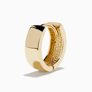 The 14K Yellow Gold Huggies are simple, small earrings with a smooth, shiny finish, shown on a plain white background.