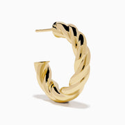 The 14K Yellow Gold Twist Hoop Earrings are shown against a white background, with soft shadows cast to the left.
