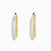 A pair of 14K Yellow Gold Knife Edge Tube Hoop Earrings with a textured finish, displayed on a plain white background and shown facing forward with visible clasps at the top.