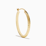 A pair of 14K Yellow Gold Knife Edge Tube Hoop Earrings with a textured finish, displayed on a plain white background and shown facing forward with visible clasps at the top.
