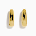 The 14 Karat Yellow Gold Chunky Oval Hoop Earrings feature a shiny finish and smooth, rounded edges, shown against a white background.