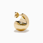 A pair of 14K Yellow Gold Chunky Stud Earrings with shiny, abstract curves and smooth surfaces, shown on a plain white background.
