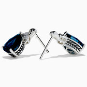 The Ocean Bleu 925 Sterling Silver London Blue Topaz and Diamond Earrings showcase teardrop-shaped London Blue Topaz stones, accented with sparkling diamonds and a leaf-patterned sterling silver setting.