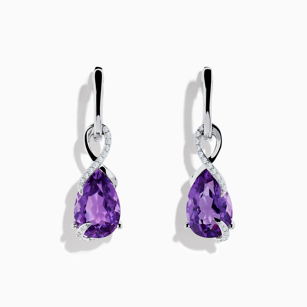 The 14K White Gold Amethyst and Diamond Earrings feature teardrop-shaped amethyst gems accented with a swirl of small white stones, all set in polished white gold and displayed on a white background.