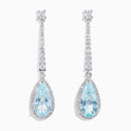 Elegant 14K white gold linear drop earrings featuring teardrop-shaped aquamarine gemstones, accented with diamonds.